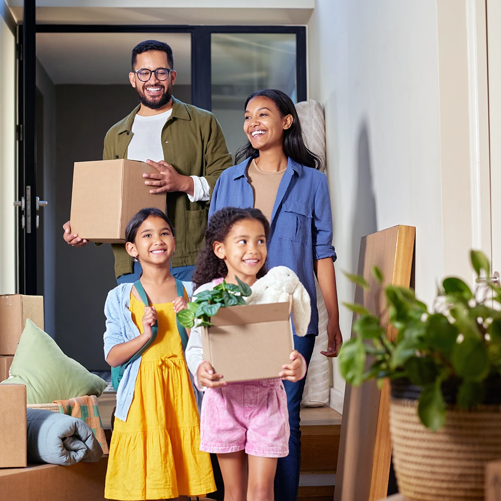 Happy family bringing boxes into new home